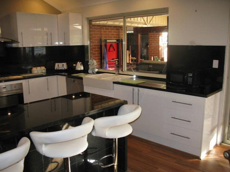 Black and white gloss kitchen with island bench and breakfast bar seating
